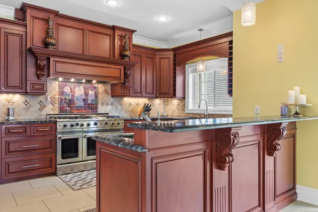 a kitchen with stainless steel appliances granite countertop a stove and a refrigerator