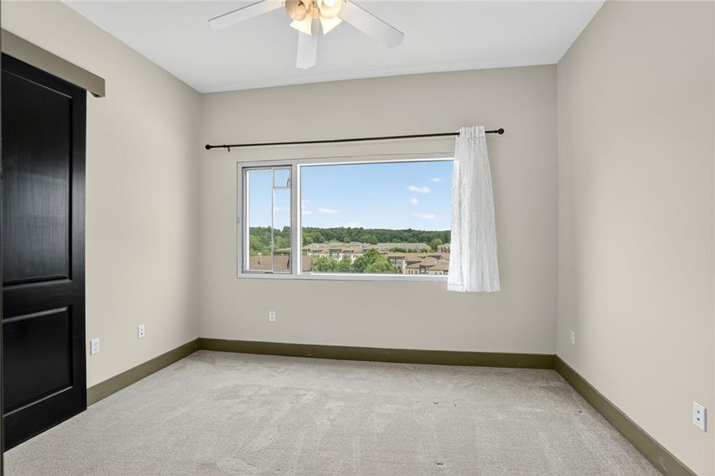 4561 Olde Perimeter Way, Unit 1207 Atlanta, GA 30346 - Photo 11 of 32 an empty room with a window