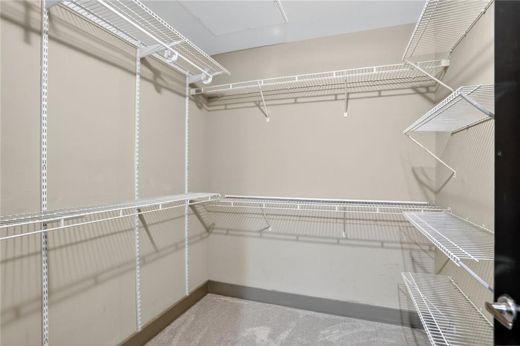 4561 Olde Perimeter Way, Unit 1207 Atlanta, GA 30346 - Photo 15 of 32 a view of an empty walk in closet
