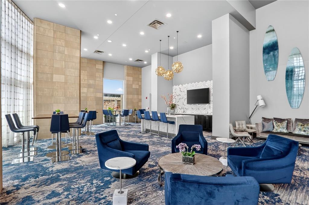 4561 Olde Perimeter Way, Unit 1207 Atlanta, GA 30346 - Photo 23 of 32 a living room with furniture and a fireplace