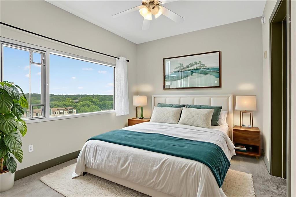 4561 Olde Perimeter Way, Unit 1207 Atlanta, GA 30346 - Photo 10 of 32 a bedroom with a bed and a painting on the wall