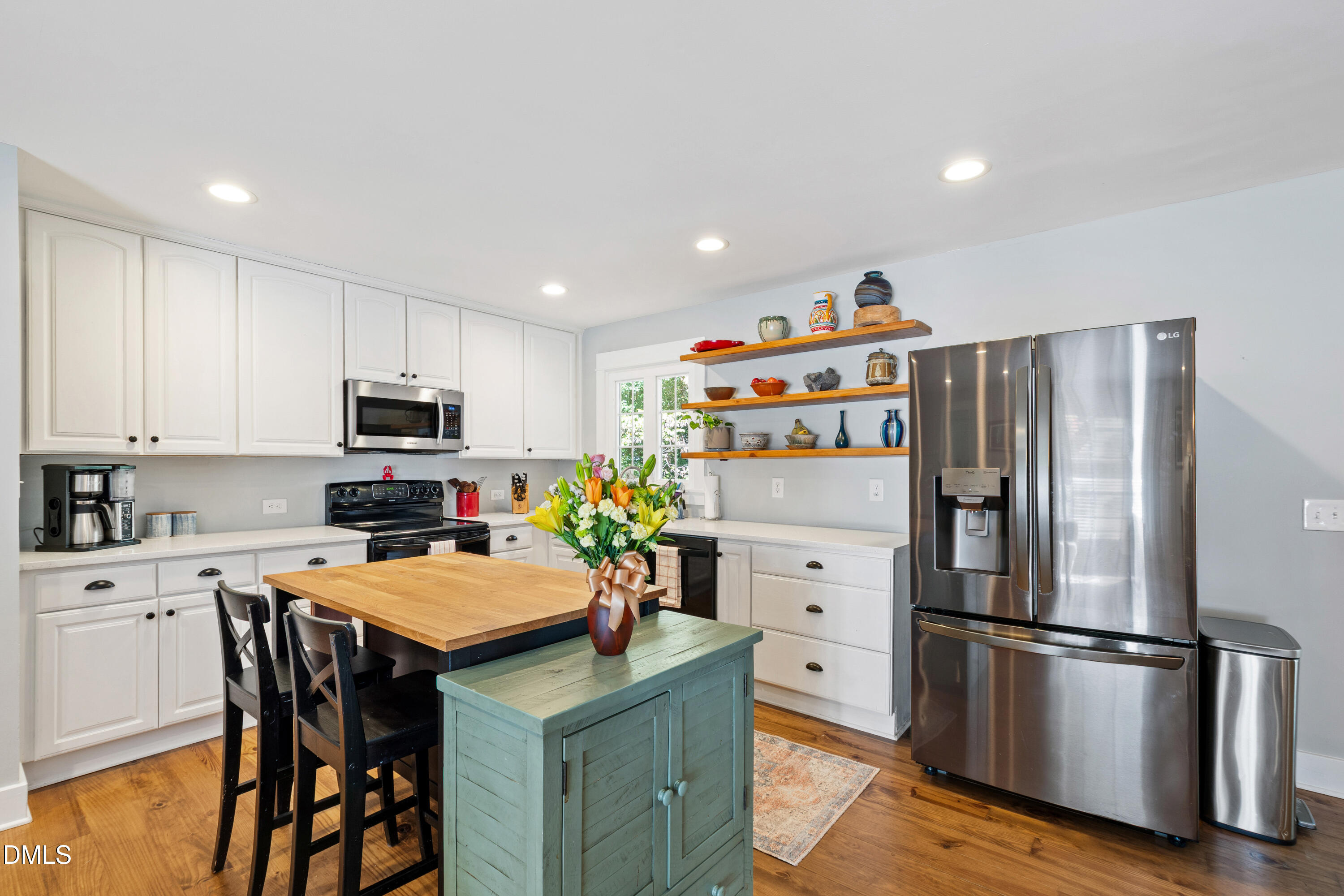 408 Troy Place Raleigh, NC 27609 - Photo 10 of 49 a kitchen with stainless steel appliances a refrigerator stove microwave and cabinets