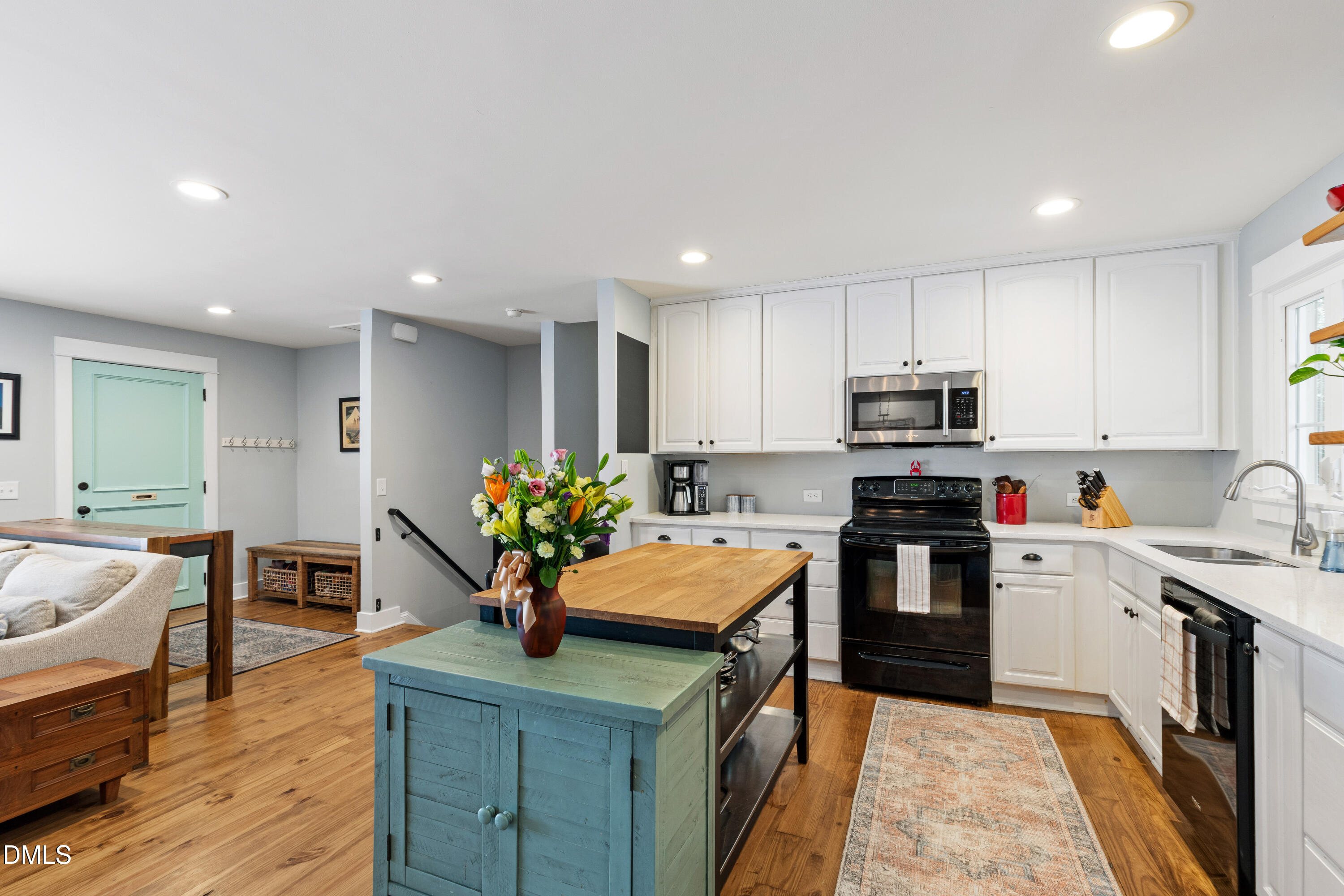 408 Troy Place Raleigh, NC 27609 - Photo 11 of 49 a kitchen with kitchen island granite countertop a sink counter space appliances and cabinets