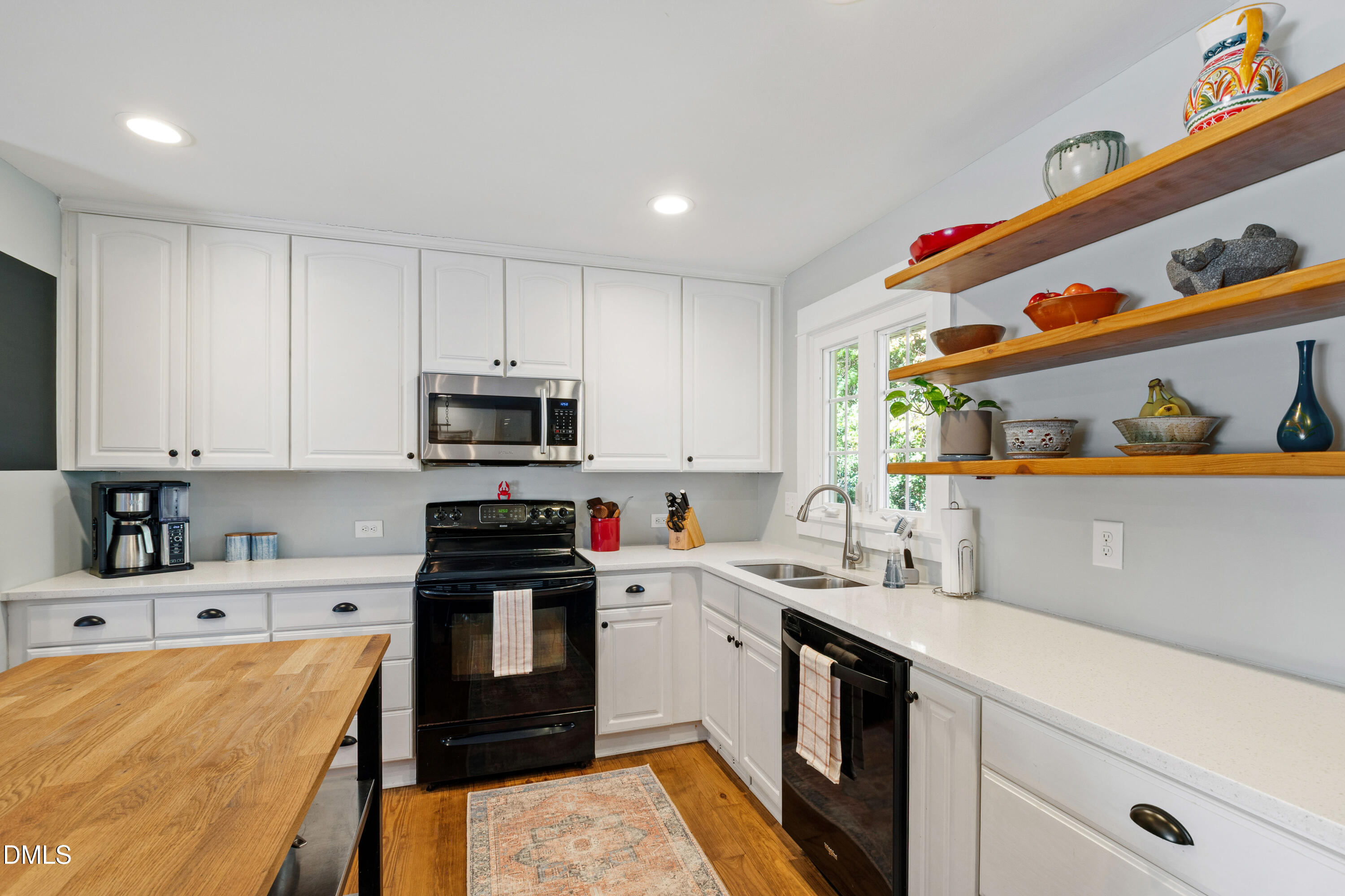 408 Troy Place Raleigh, NC 27609 - Photo 12 of 49 a kitchen with stainless steel appliances granite countertop a sink and cabinets