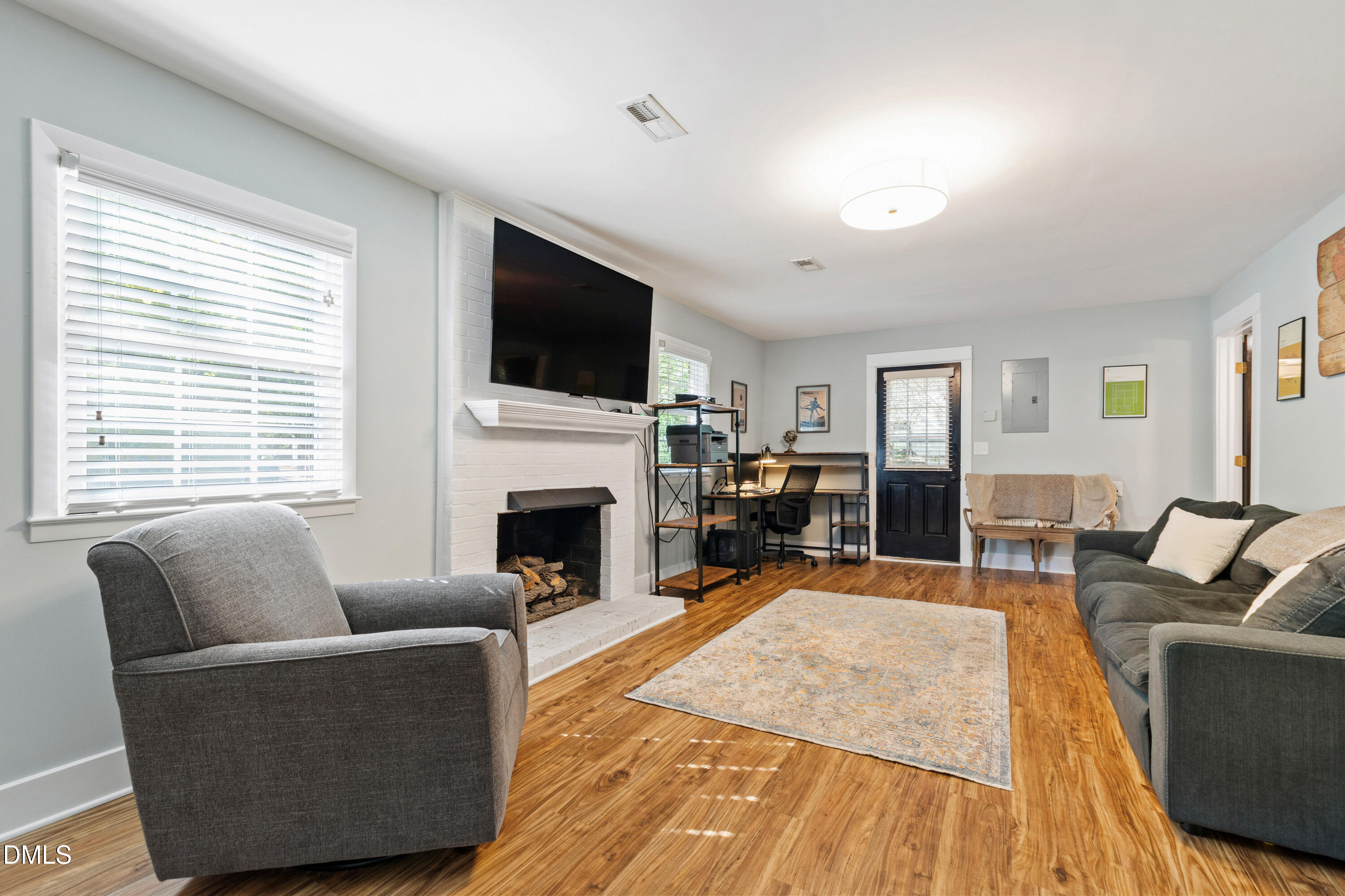 408 Troy Place Raleigh, NC 27609 - Photo 17 of 49 a living room with furniture fireplace and a flat screen tv