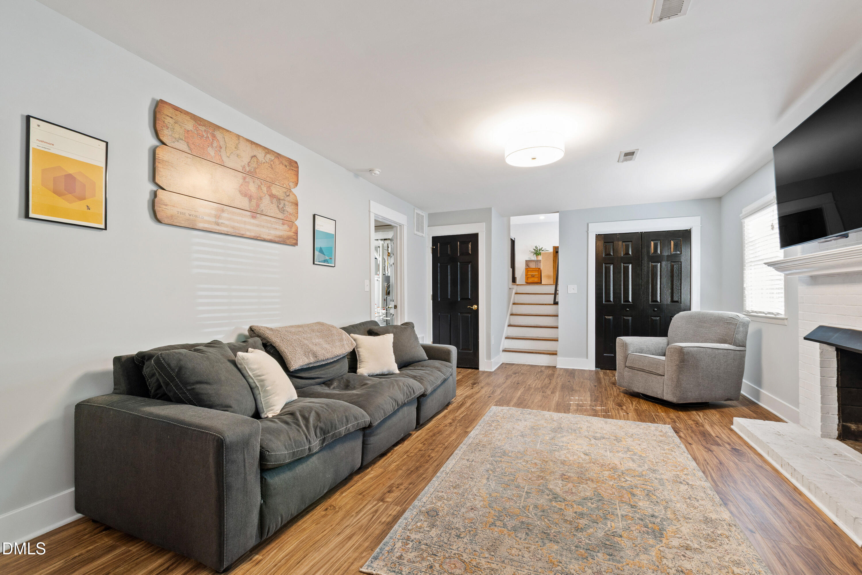 408 Troy Place Raleigh, NC 27609 - Photo 19 of 49 a living room with furniture a flat screen tv and a couch