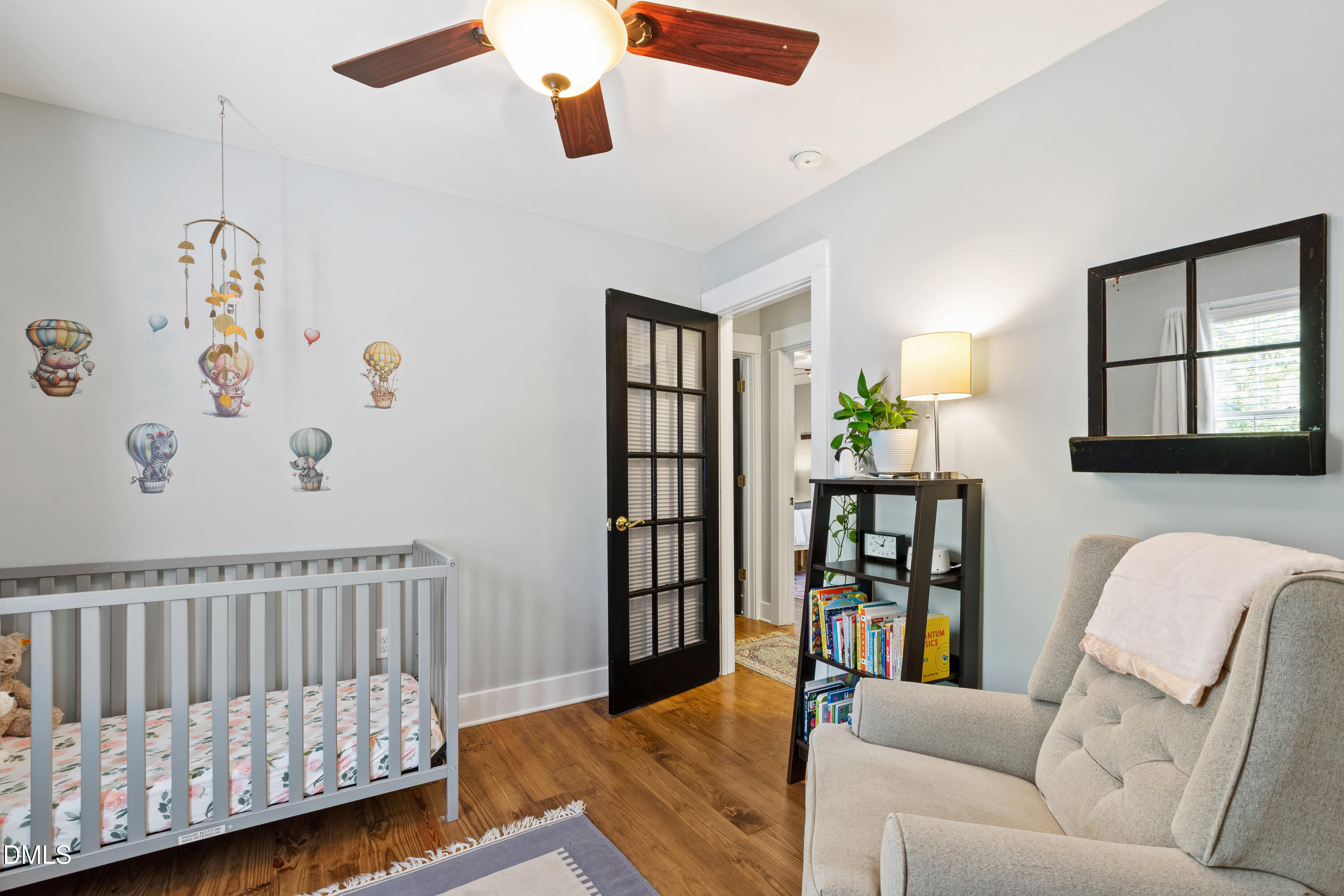 408 Troy Place Raleigh, NC 27609 - Photo 32 of 49 a living room with furniture and a baby crib