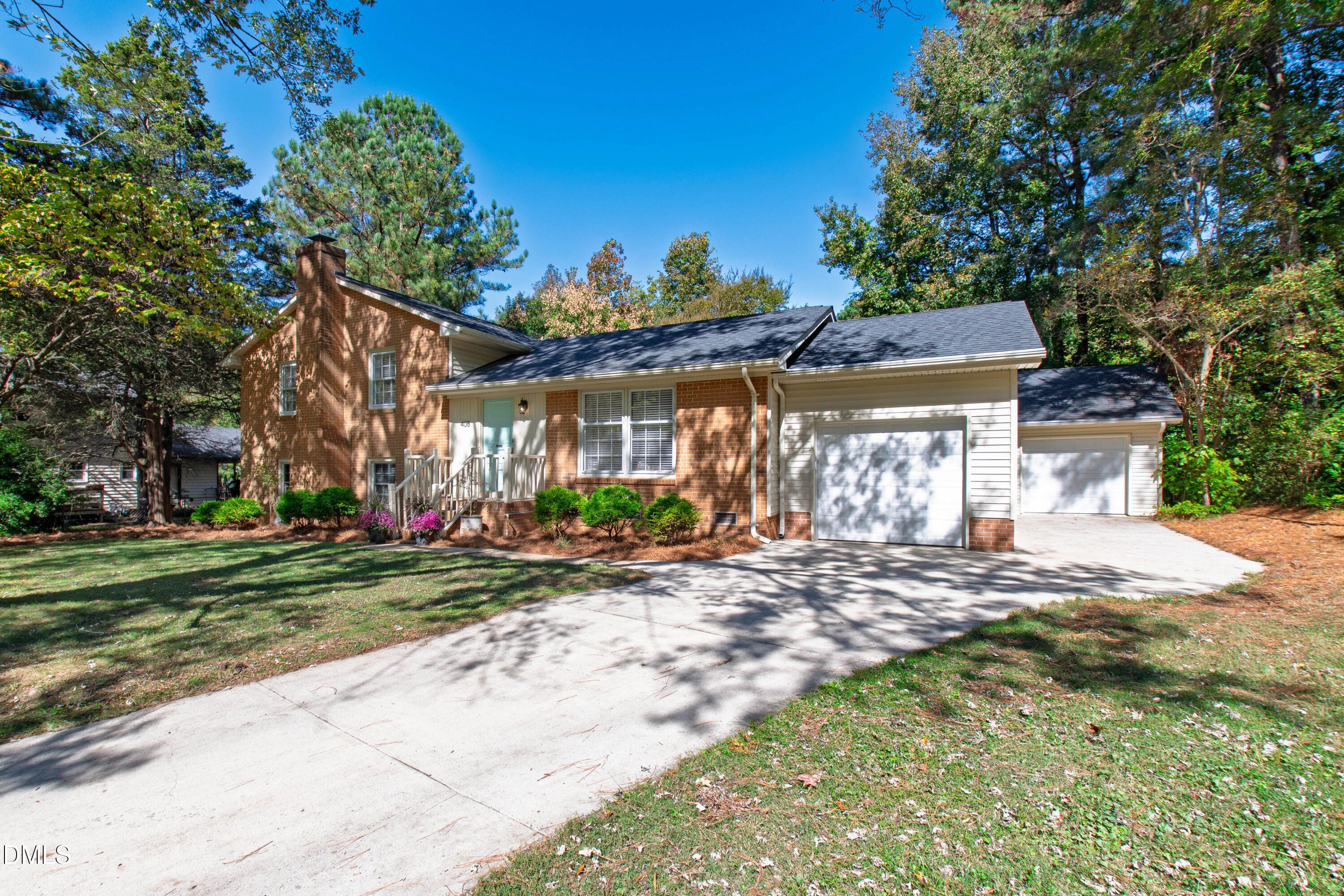 408 Troy Place Raleigh, NC 27609 - Photo 45 of 49 a front view of a house with a yard and potted plants