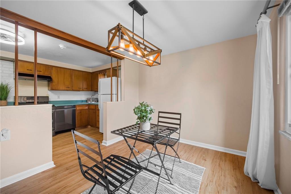 301 Orchard Spring Road Pittsburgh, PA 15220 - Photo 6 of 33 Dining room also has a large window, with updated farmhouse lighting