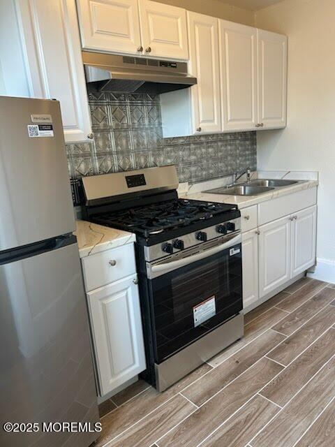 1107 Grand Avenue, Unit 4 Asbury Park, NJ 07712 - Photo 2 of 6 a kitchen with a stove and a white refrigerator