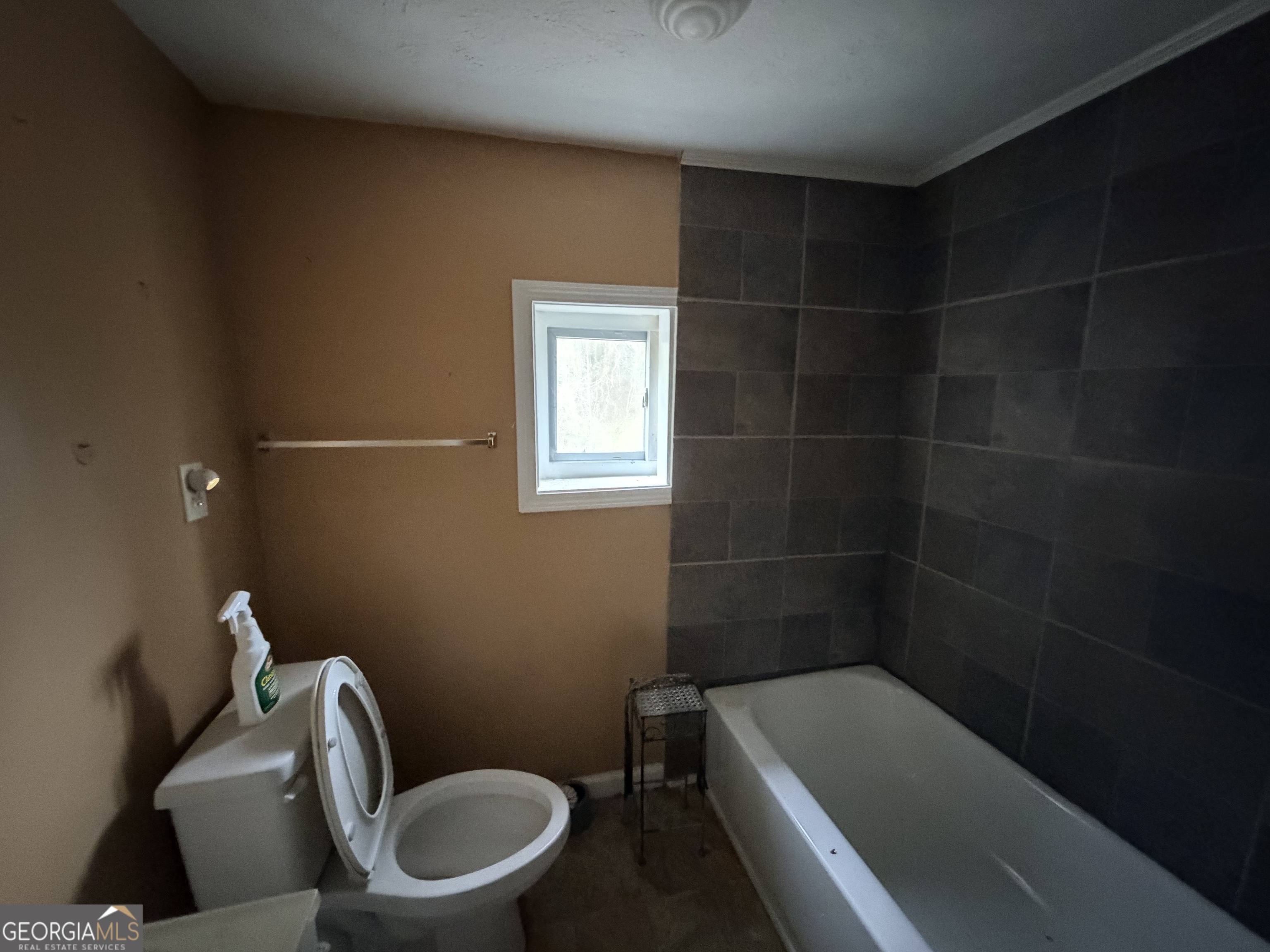 1966 Lake Rockaway Road Northwest Conyers, GA 30012 - Photo 16 of 24 a bathroom with a toilet a sink and bathtub