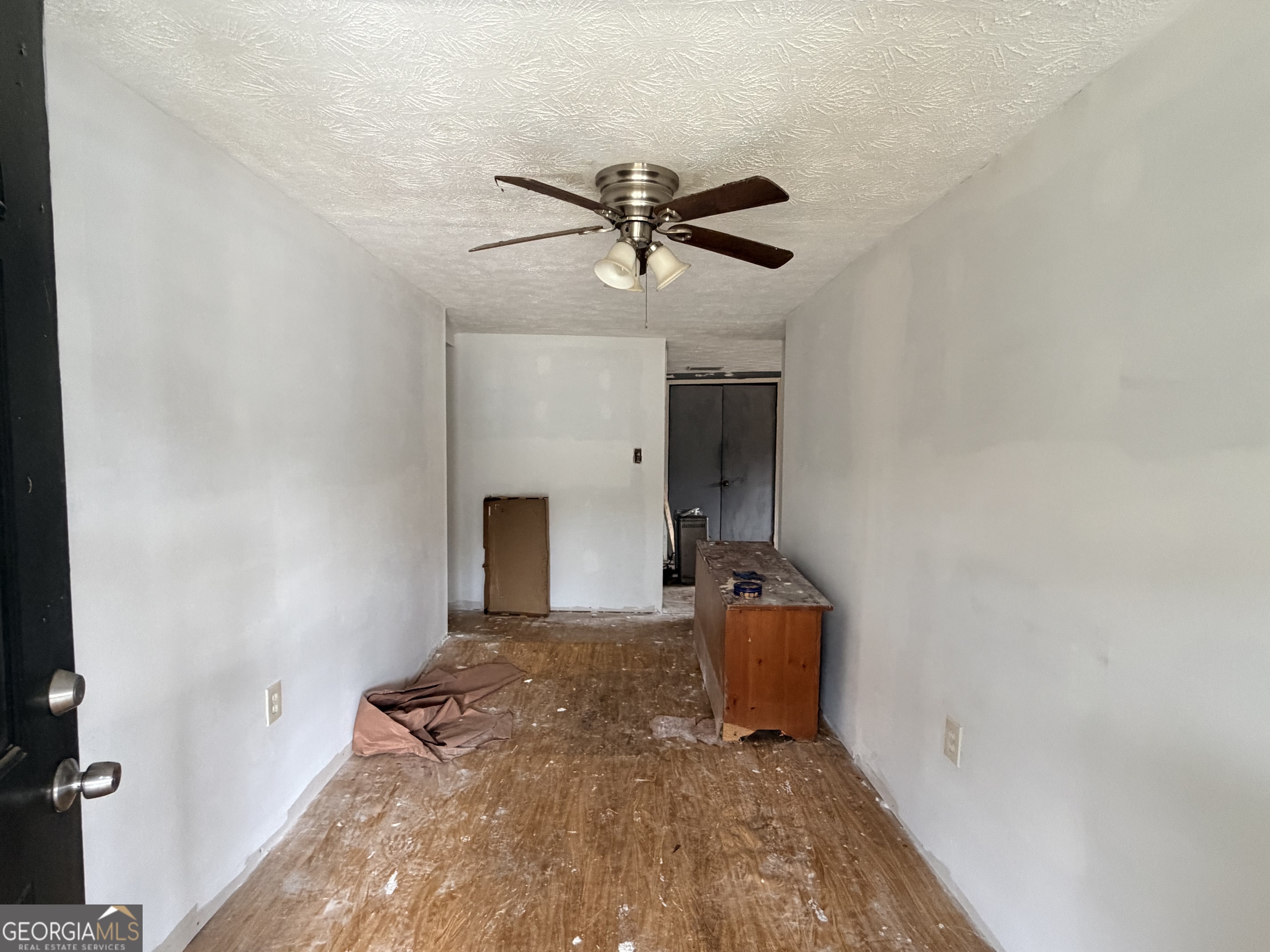 1966 Lake Rockaway Road Northwest Conyers, GA 30012 - Photo 3 of 24 a view of a livingroom with a fireplace and a ceiling fan