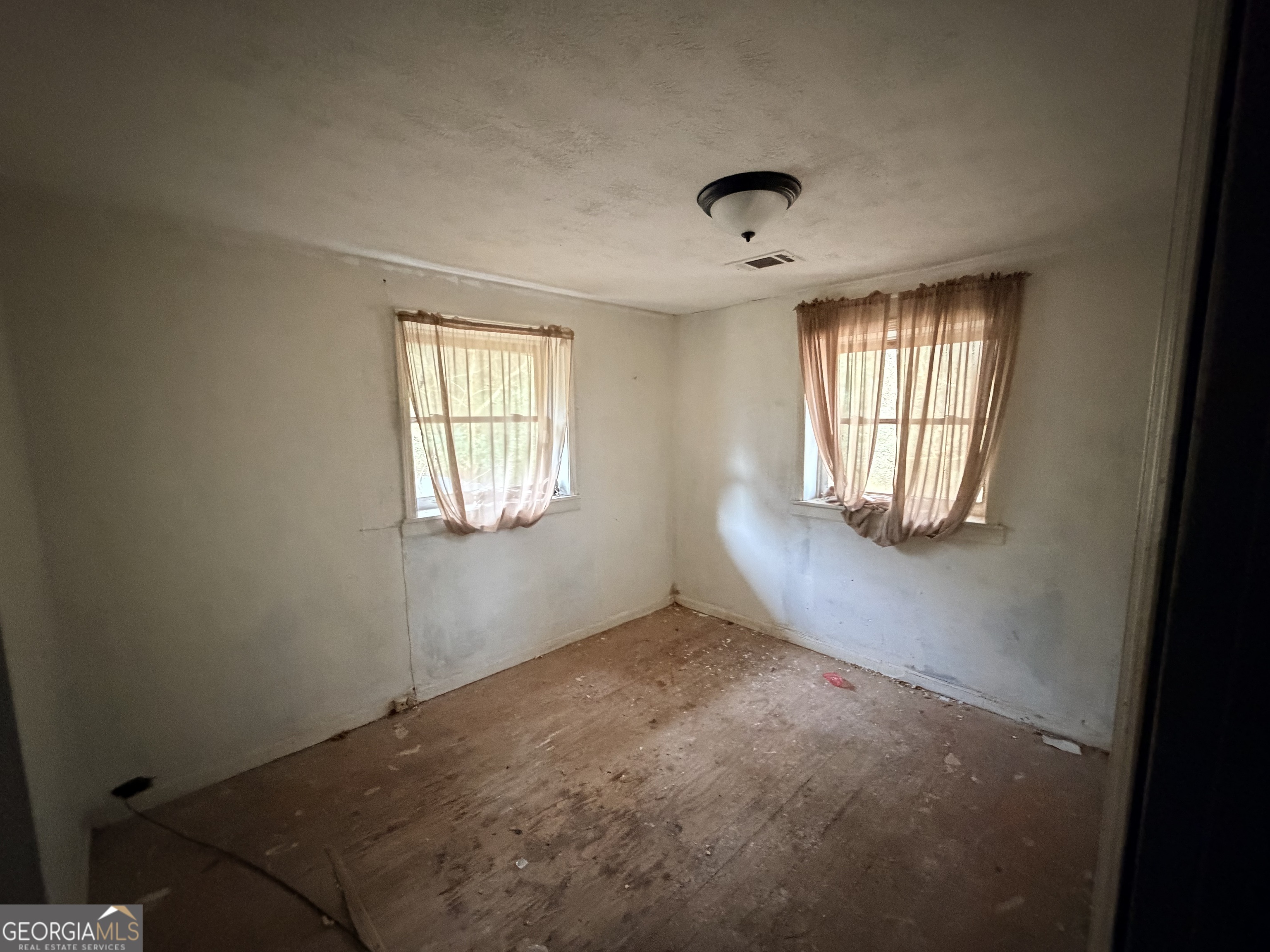1966 Lake Rockaway Road Northwest Conyers, GA 30012 - Photo 10 of 24 an empty room with windows