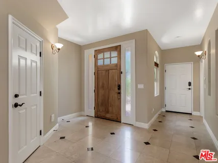 a living room with a fireplace and a flat screen tv