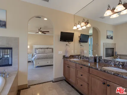a bathroom with a toilet a sink a light fixture and a mirror
