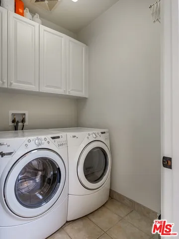 a view of swimming pool with outdoor seating and house in the background