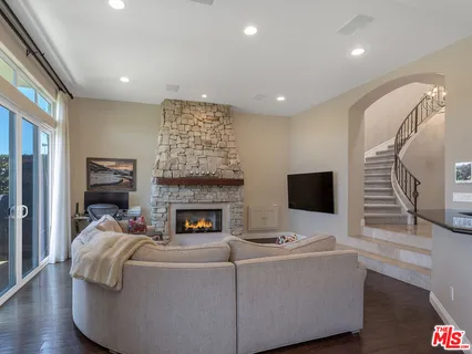 a kitchen with stainless steel appliances kitchen island granite countertop a stove and white cabinets