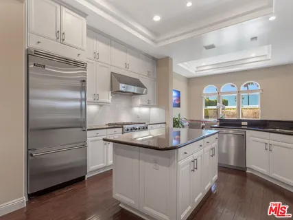a living room with couches and a flat screen tv