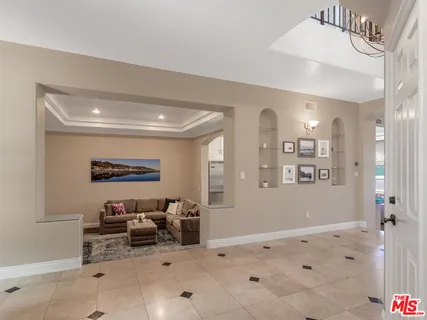 a spacious bedroom with a bed and a large window