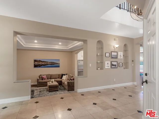 a spacious bedroom with a bed and a large window