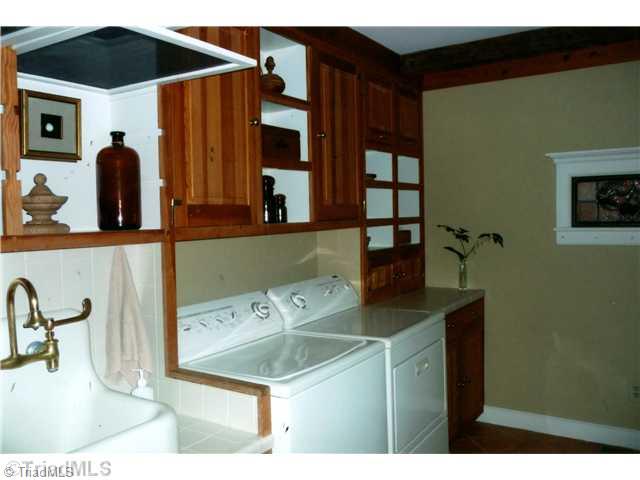 8262 Ballard Road Colfax, NC 27235 - Photo 15 of 16 Laundry Room. In addition to a large wash sink there is a built-in desk allows use as a sewing and/or crafts room. Note screens over sink for drying sweaters