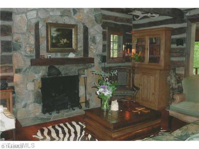 8262 Ballard Road Colfax, NC 27235 - Photo 4 of 16 Living Room. Entry to the original log home is warmed by a stone fireplace