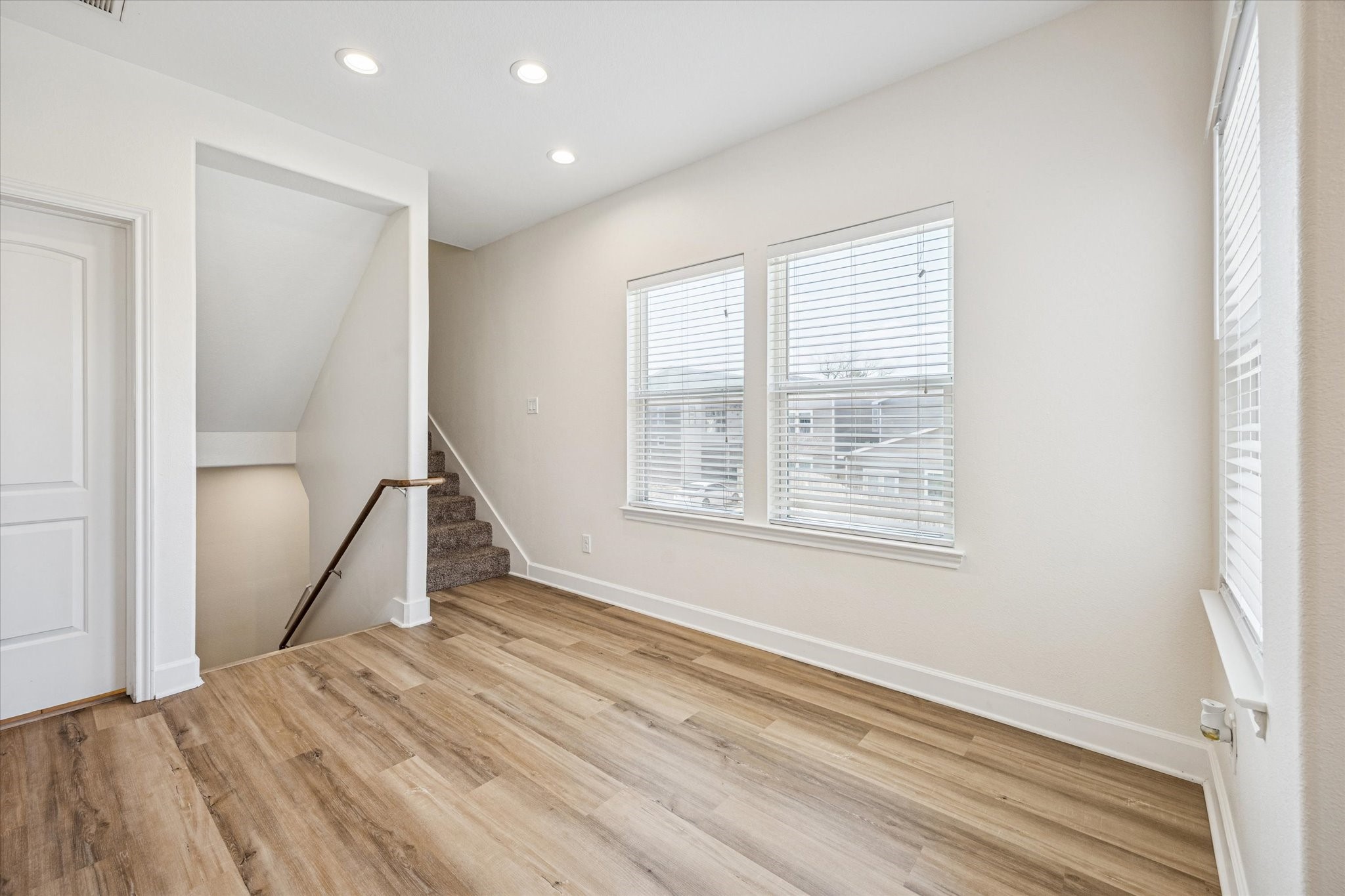 5402 Jonathan Lane Houston, TX 77011 - Photo 11 of 33 a view of a room with wooden floor and staircase