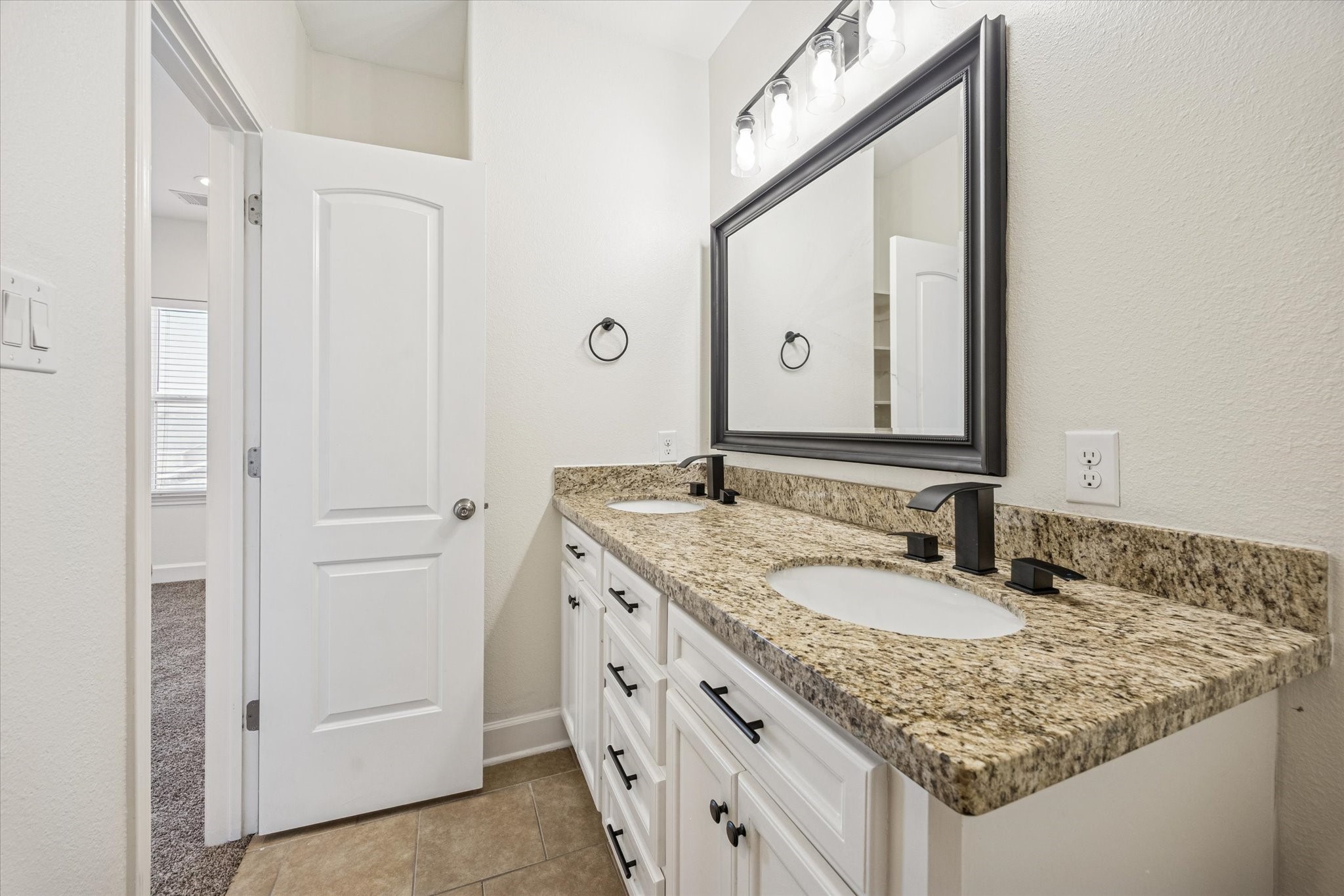 5402 Jonathan Lane Houston, TX 77011 - Photo 18 of 33 a bathroom with a granite countertop sink and a mirror