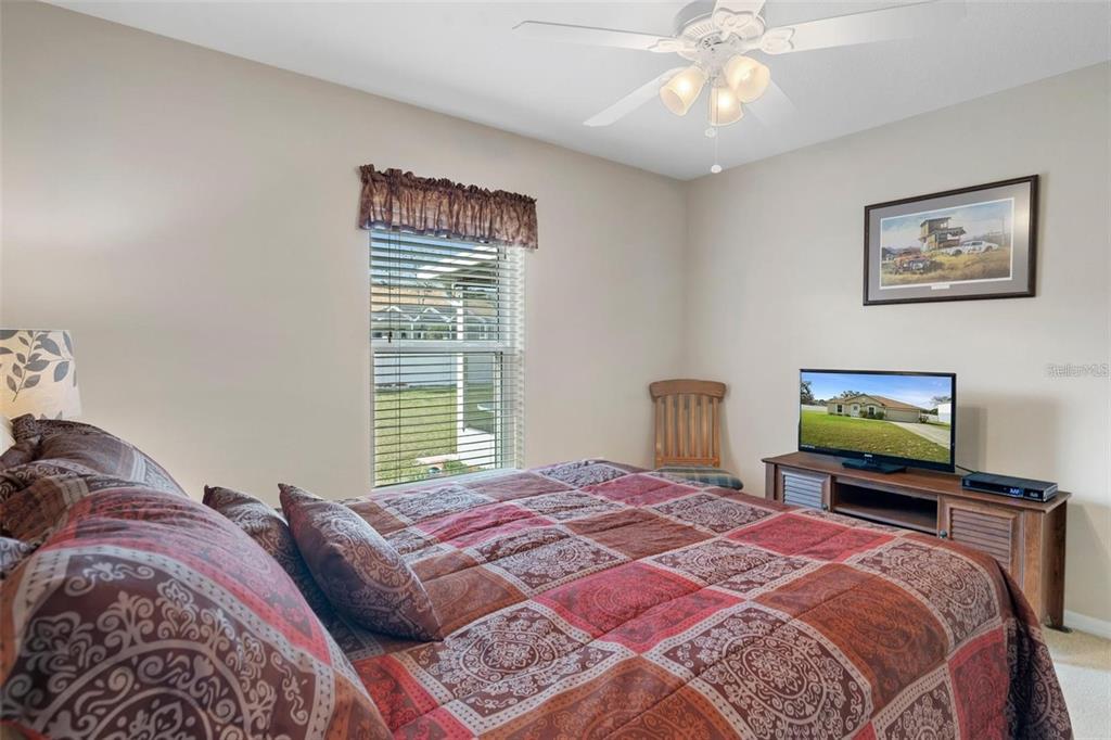 12255 Linden Drive Spring Hill, FL 34608 - Photo 14 of 26 a bedroom with a bed and a chandelier