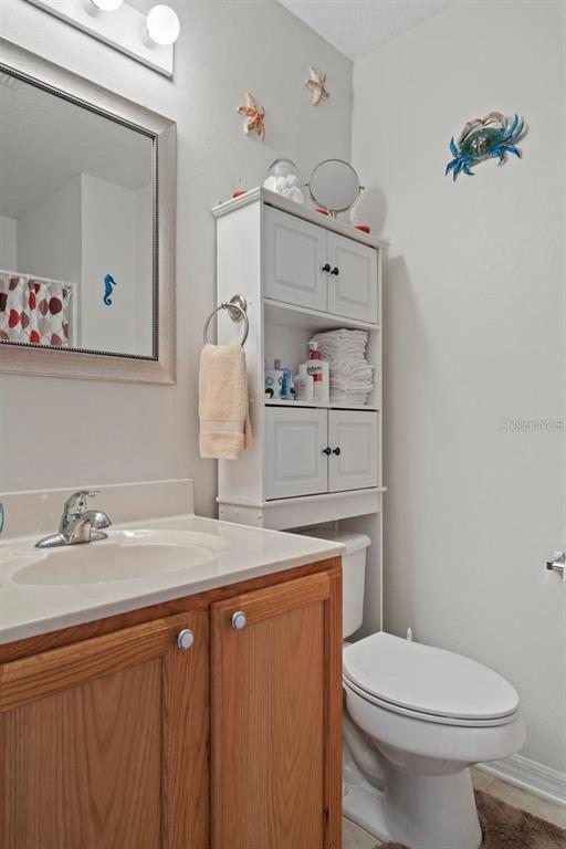 12255 Linden Drive Spring Hill, FL 34608 - Photo 21 of 26 a bathroom with a sink a toilet and vanity