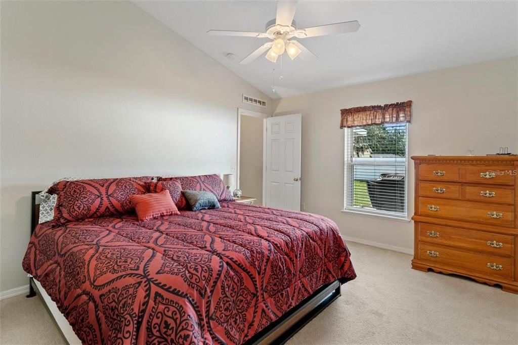 12255 Linden Drive Spring Hill, FL 34608 - Photo 23 of 26 a bedroom with a bed a dresser and a window