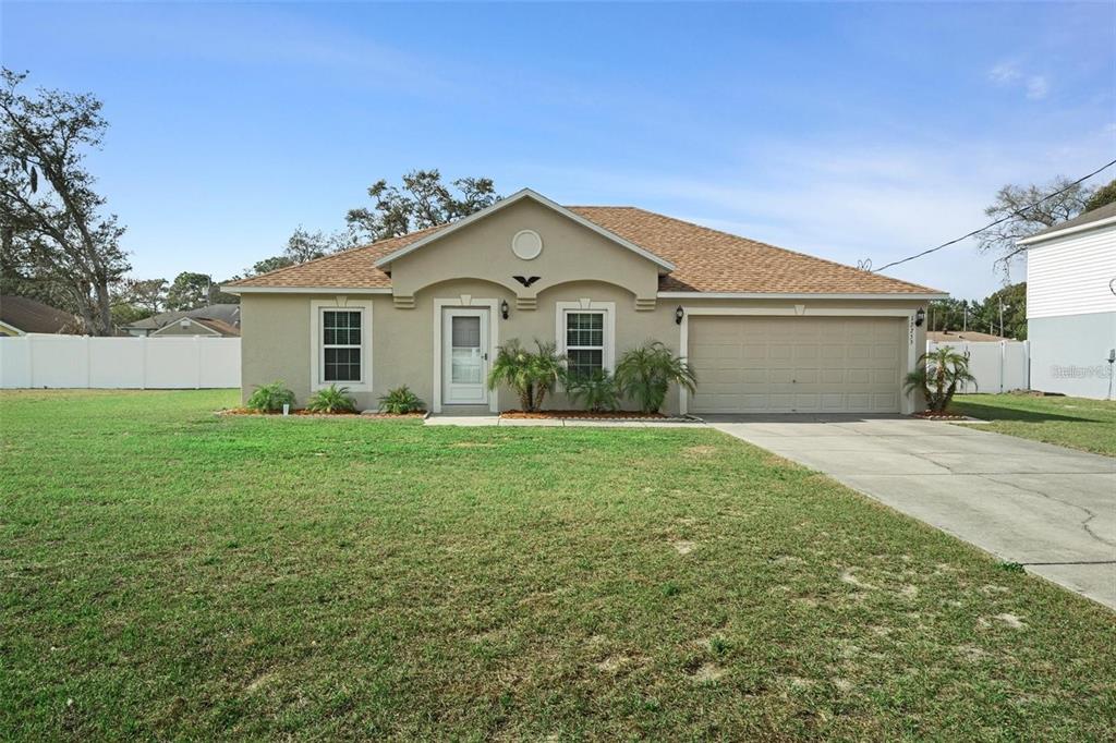 12255 Linden Drive Spring Hill, FL 34608 - Photo 26 of 26 a front view of a house with a garden and yard