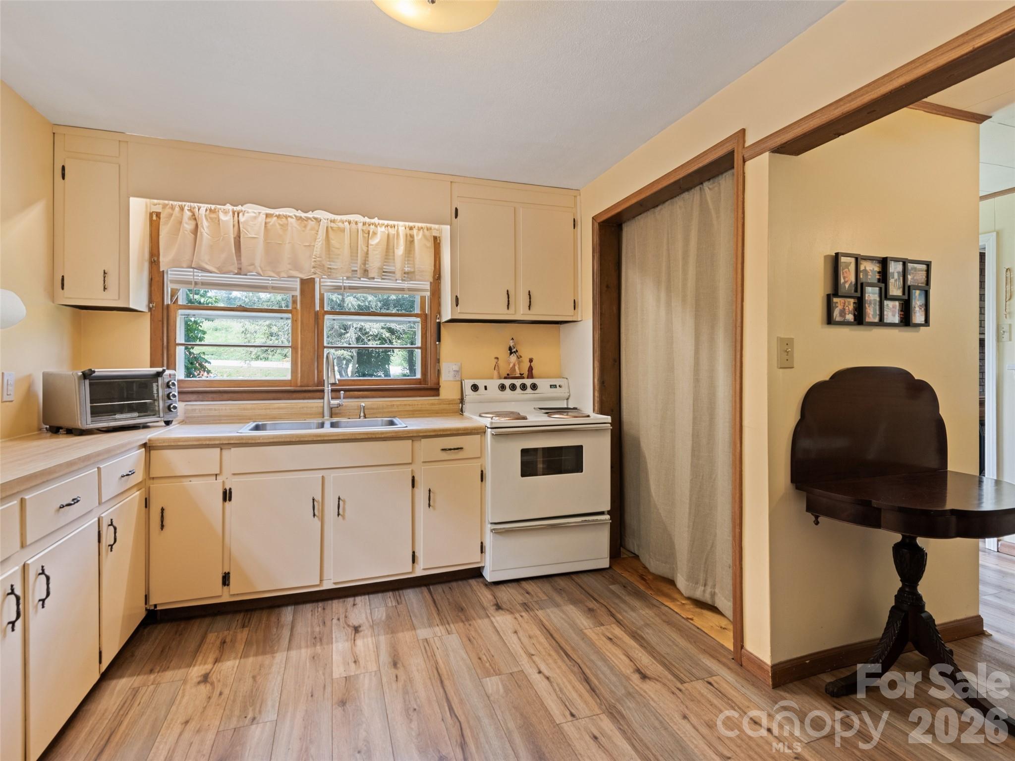 1714 Iron Duff Road Waynesville, NC 28785 - Photo 11 of 25 a kitchen with stainless steel appliances granite countertop a stove a sink and a refrigerator