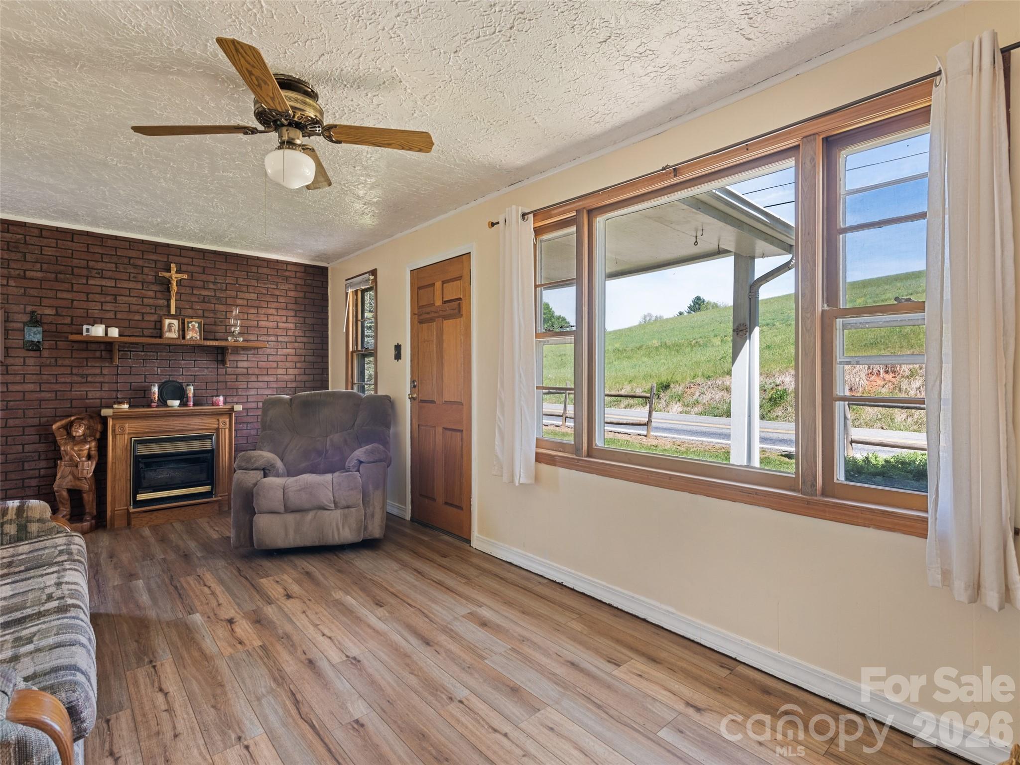 1714 Iron Duff Road Waynesville, NC 28785 - Photo 15 of 25 a living room with furniture and a fireplace