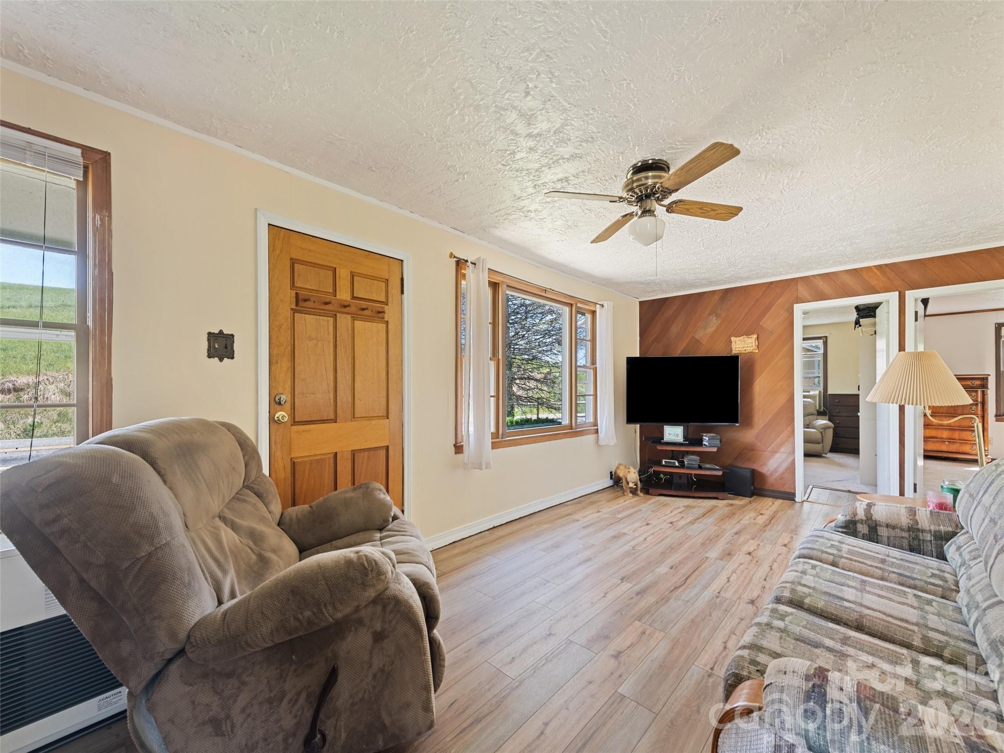 1714 Iron Duff Road Waynesville, NC 28785 - Photo 16 of 25 a living room with furniture a flat screen tv and a large window