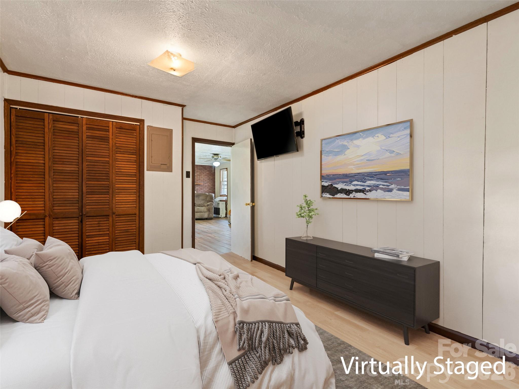 1714 Iron Duff Road Waynesville, NC 28785 - Photo 20 of 25 a bedroom with a bed and a wall painting