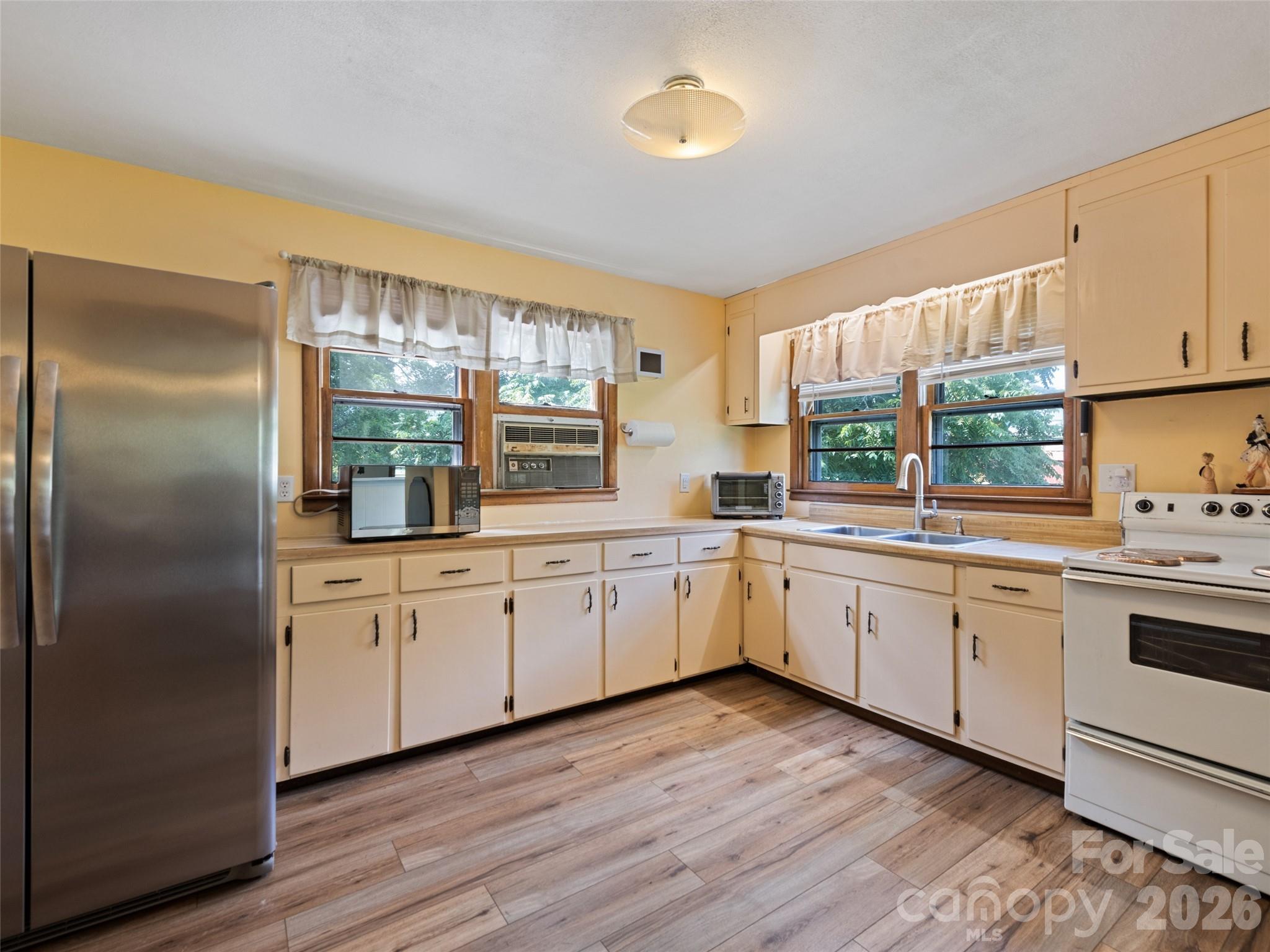 1714 Iron Duff Road Waynesville, NC 28785 - Photo 10 of 25 a kitchen with granite countertop stainless steel appliances a sink cabinets and a large window
