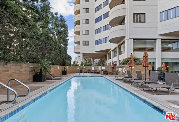 a view of a swimming pool with sitting area