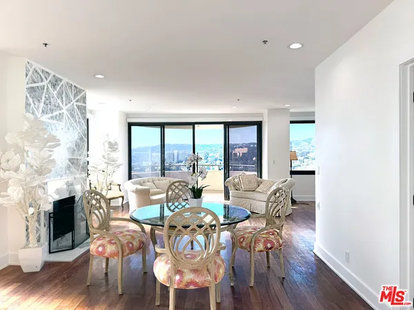 a living room with fireplace furniture and a floor to ceiling window