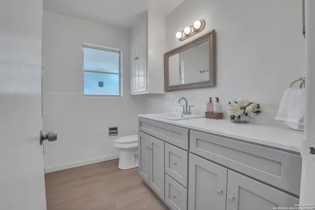 a bathroom with a toilet sink and mirror