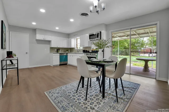 a view of a dining room with furniture window and wooden floor
