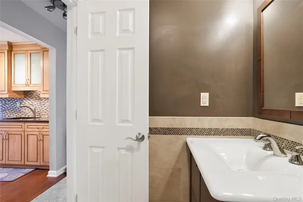 a bathroom with a granite countertop sink and a mirror