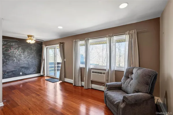 a living room with furniture window and wooden floor