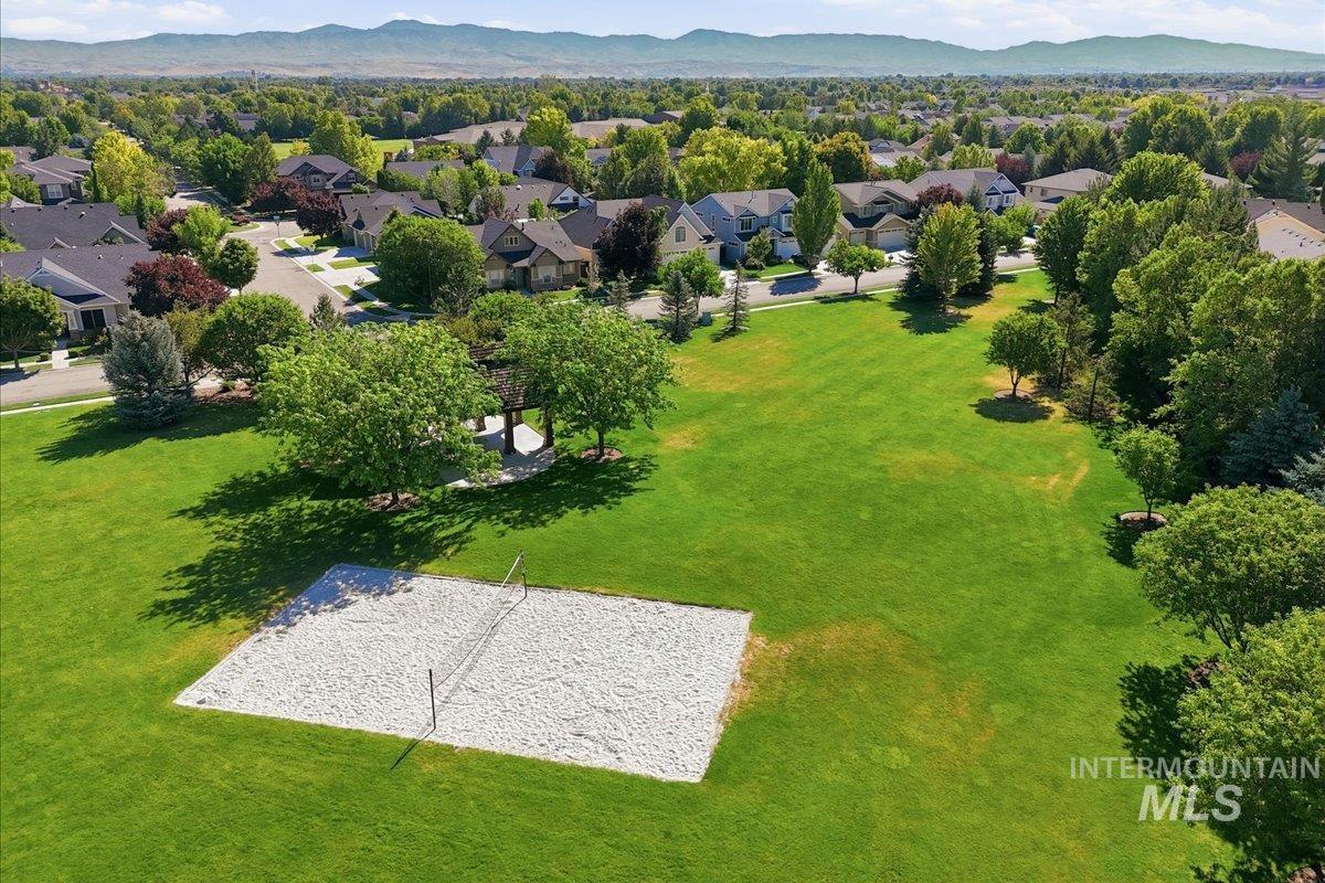 1303 West Brando Street Meridian, ID 83646 - Photo 49 of 49 Expansive green space featuring a sand volleyball court, mature trees, and a gazebo