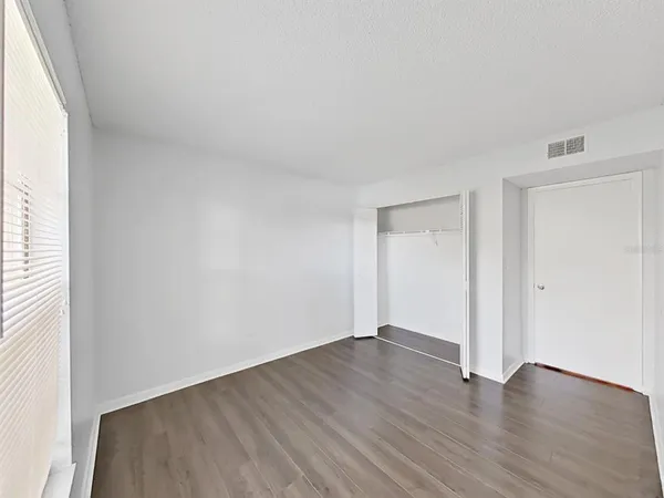 a view of a workspace with furniture and wooden floor