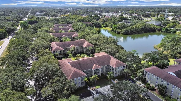 an aerial view of a house with a yard and lake view