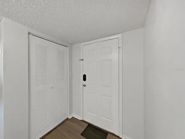 a view of a hallway with wooden floor and a sink
