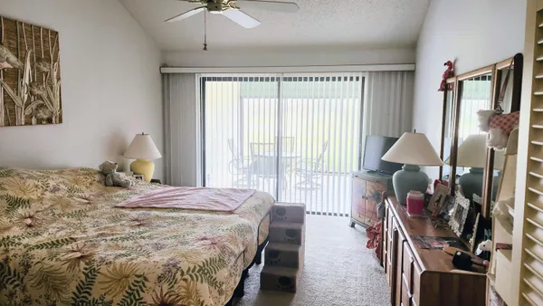 a bedroom with bed and a chandelier