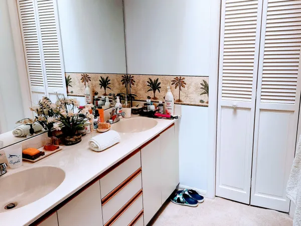 a view of a sink and dishwasher with wooden floor