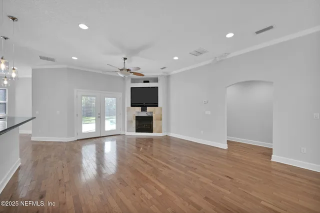 a view of empty room with wooden floor